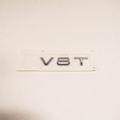 NEW AUDI A8 4H FRONT BUMPER SIDE EMBLEM INSCRIPTION BADGE 4H0853601 2ZZ ORIGINAL